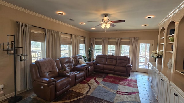 living room featuring crown molding, plenty of natural light, and dark tile patterned flooring