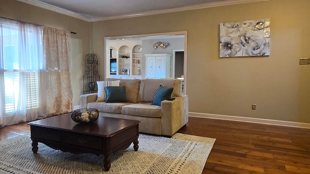 living room featuring hardwood / wood-style floors, built in features, and ornamental molding