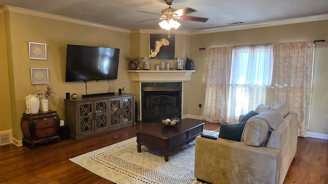 living room featuring hardwood / wood-style flooring, crown molding, and ceiling fan