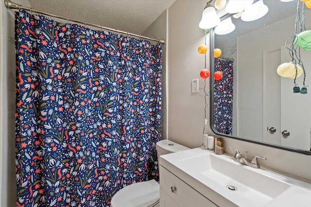 bathroom featuring vanity, toilet, curtained shower, and a textured ceiling