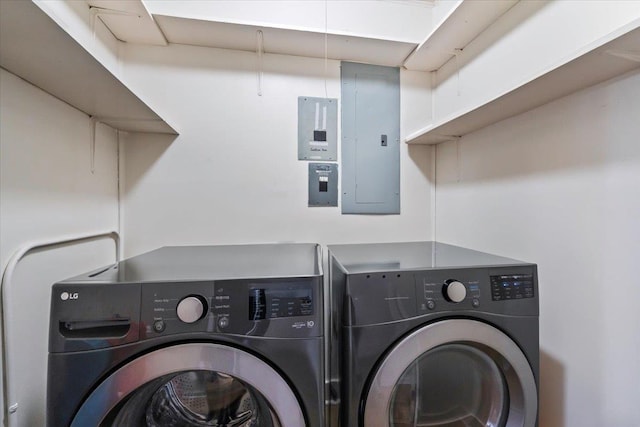 clothes washing area featuring electric panel and washer and dryer