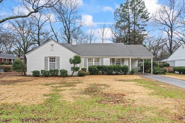 single story home with a carport and a front lawn