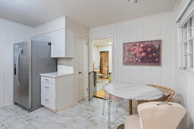 kitchen with white cabinets and stainless steel fridge with ice dispenser