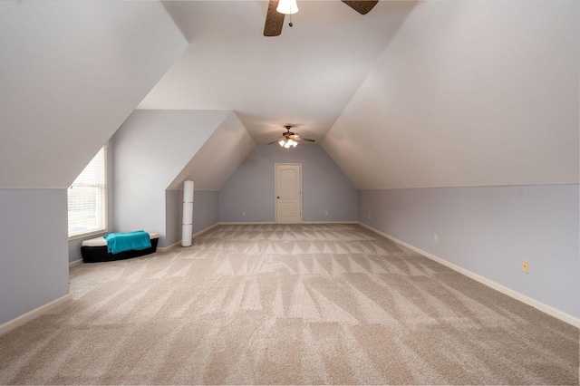 additional living space featuring ceiling fan, lofted ceiling, and light carpet