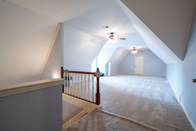 bonus room with vaulted ceiling, light carpet, and ceiling fan