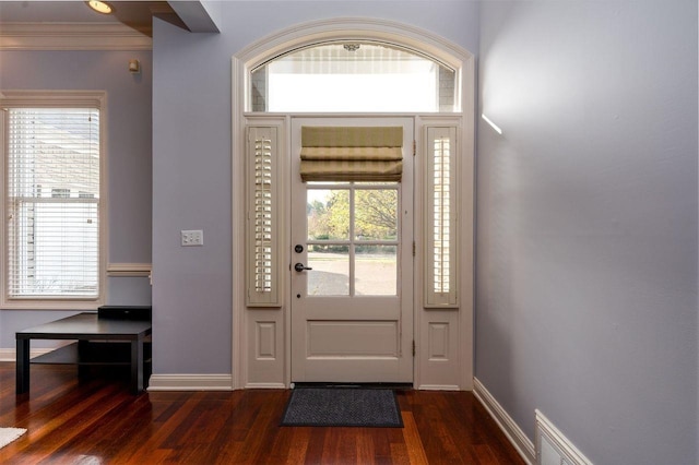 entrance foyer featuring crown molding and dark hardwood / wood-style floors