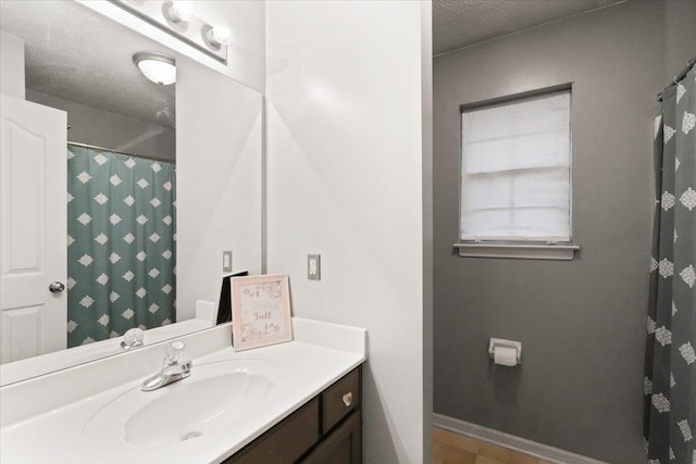 bathroom featuring vanity and a textured ceiling