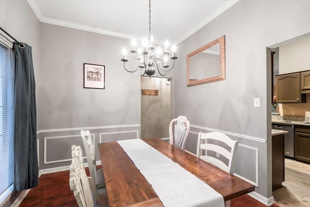 dining room featuring dark hardwood / wood-style flooring, crown molding, and an inviting chandelier