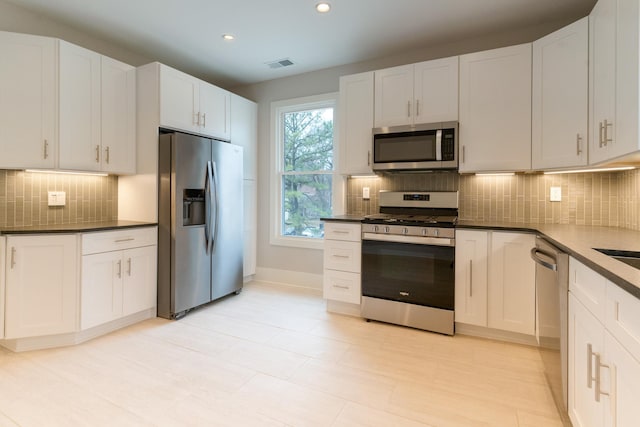 kitchen featuring appliances with stainless steel finishes and white cabinets