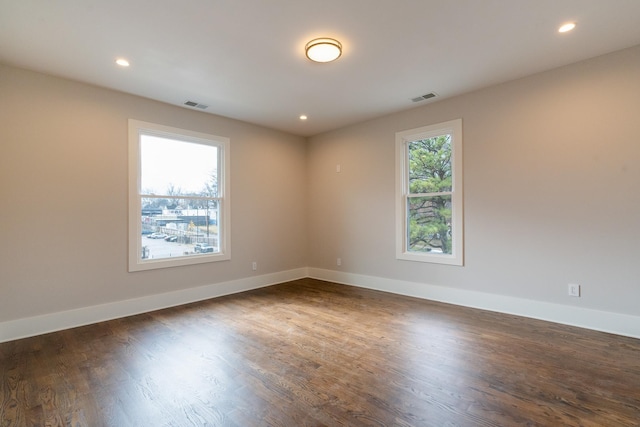 unfurnished room featuring dark hardwood / wood-style flooring