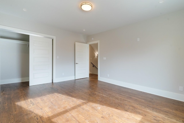 unfurnished bedroom with wood-type flooring and a closet