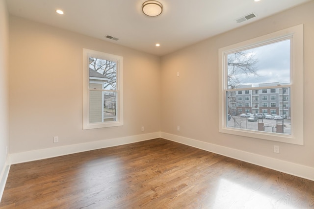 unfurnished room with hardwood / wood-style floors