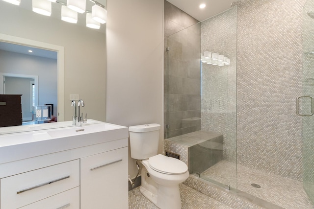 bathroom with tile patterned flooring, toilet, vanity, and a shower with shower door