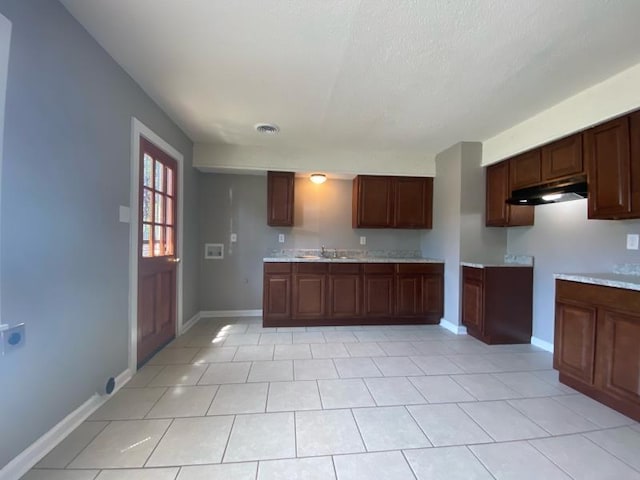 kitchen with sink and light tile patterned floors