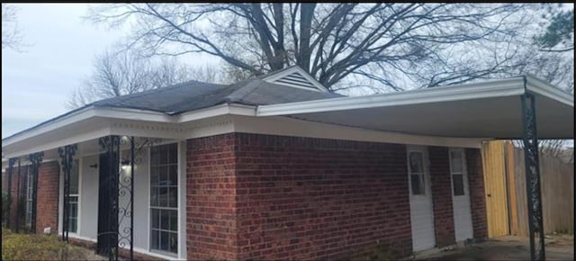 view of property exterior with a carport