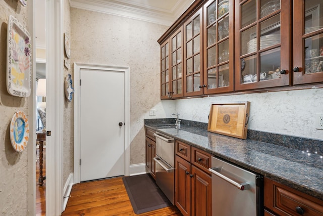 kitchen featuring ornamental molding, dark hardwood / wood-style flooring, sink, and dark stone countertops