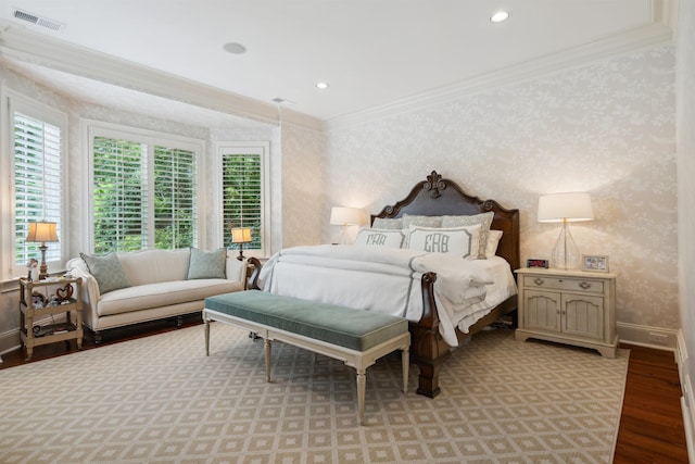 bedroom featuring ornamental molding and light wood-type flooring