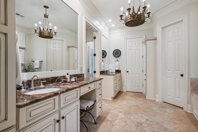 bathroom with crown molding, vanity, and a chandelier