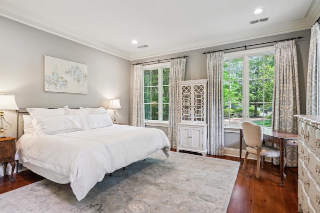 bedroom featuring ornamental molding and dark hardwood / wood-style floors