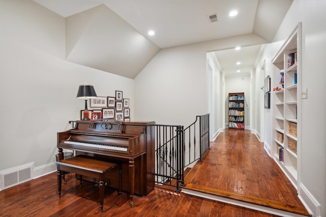 misc room with hardwood / wood-style flooring and vaulted ceiling