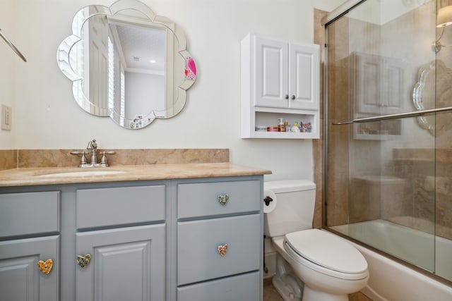 full bathroom featuring vanity, enclosed tub / shower combo, and toilet