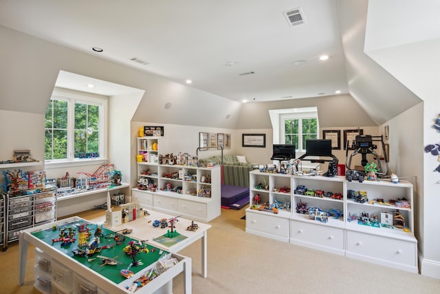 game room featuring a wealth of natural light, vaulted ceiling, and light colored carpet