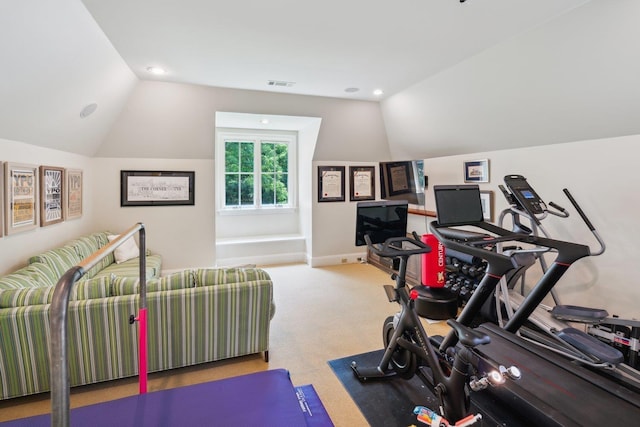 workout room with vaulted ceiling and carpet floors