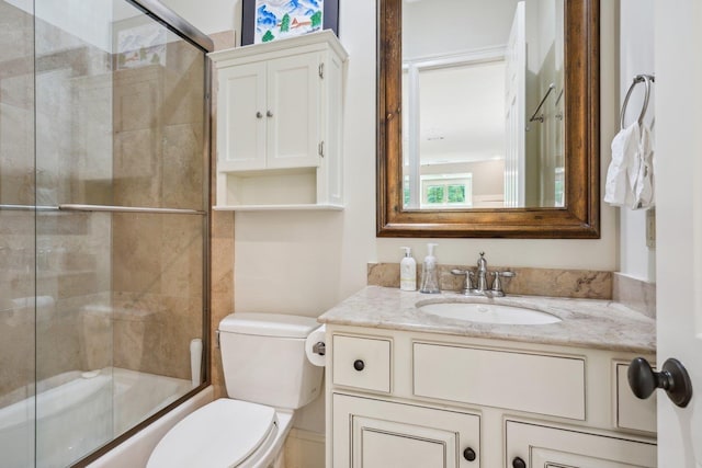 full bathroom with vanity, shower / bath combination with glass door, and toilet