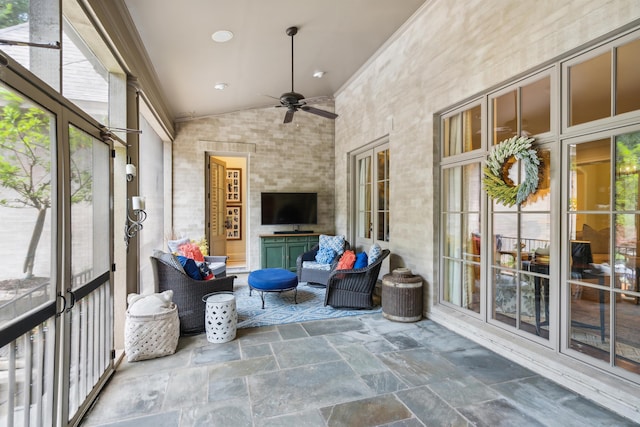 sunroom / solarium with lofted ceiling and ceiling fan