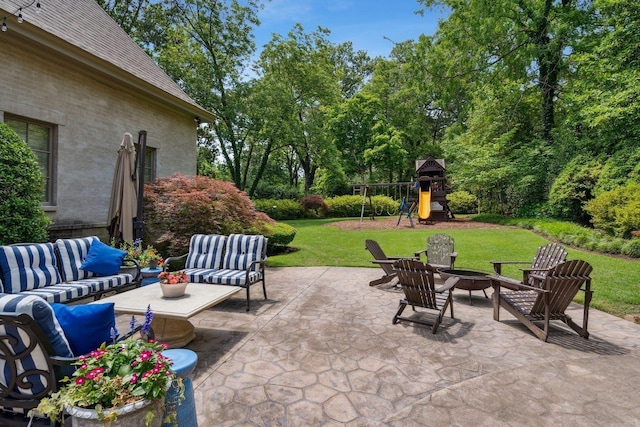 view of patio / terrace with an outdoor living space with a fire pit and a playground