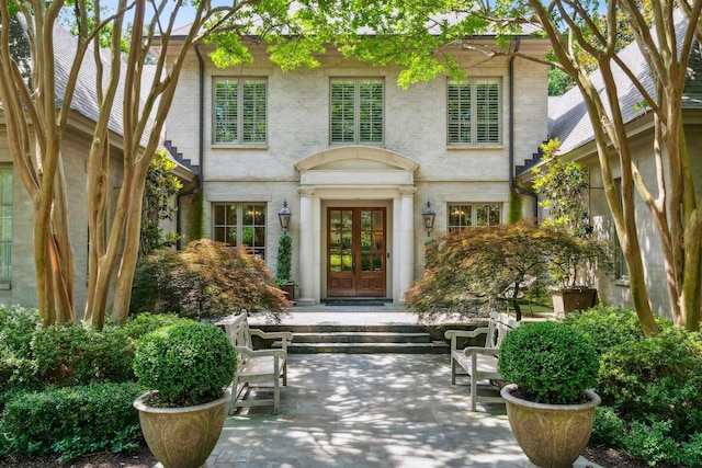 property entrance with a patio and french doors