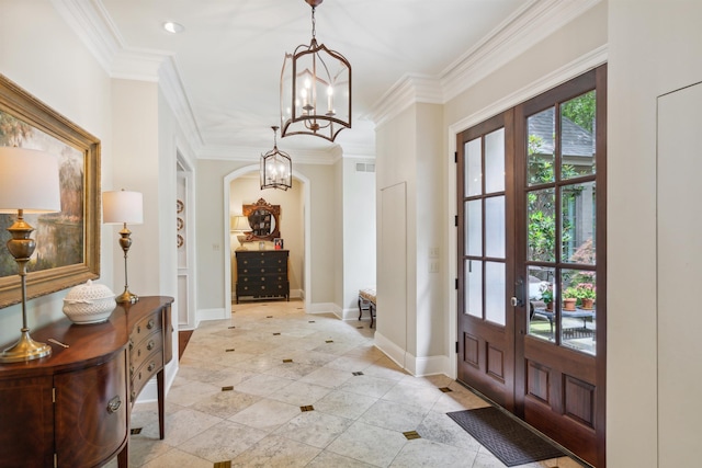 interior space with crown molding, light tile patterned floors, an inviting chandelier, and french doors