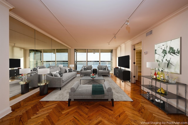 living room with parquet floors, a wall of windows, rail lighting, and crown molding