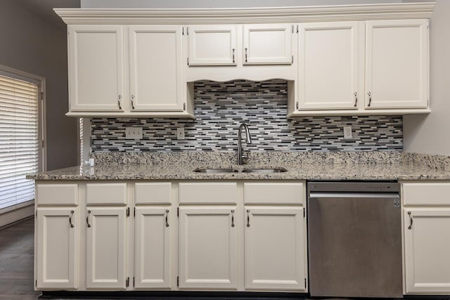 kitchen with light stone counters, sink, and dishwasher