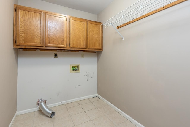 laundry room with cabinets, light tile patterned flooring, hookup for a washing machine, and hookup for an electric dryer