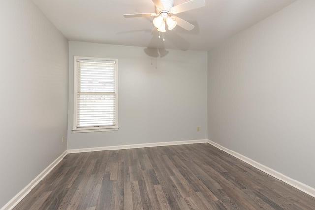 empty room featuring dark wood-type flooring and ceiling fan