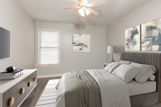 bedroom with dark hardwood / wood-style floors and ceiling fan