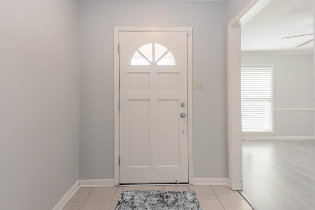 foyer with light tile patterned flooring and ceiling fan