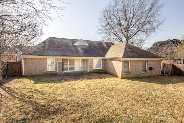 back of property featuring a yard and a patio area