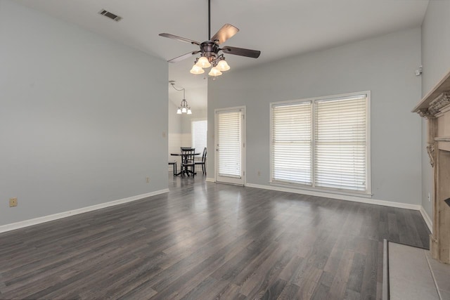 unfurnished living room with dark wood-type flooring and ceiling fan with notable chandelier