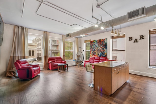 kitchen featuring rail lighting, a center island, and dark hardwood / wood-style floors