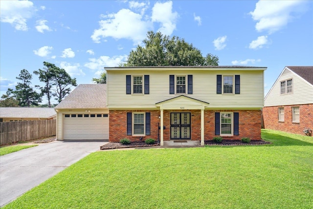 view of front of home with a garage and a front lawn