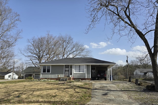 view of front of house with a carport and a front lawn