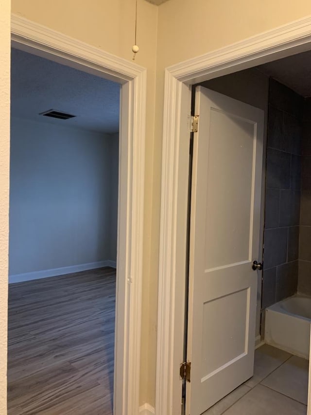 corridor featuring tile patterned flooring