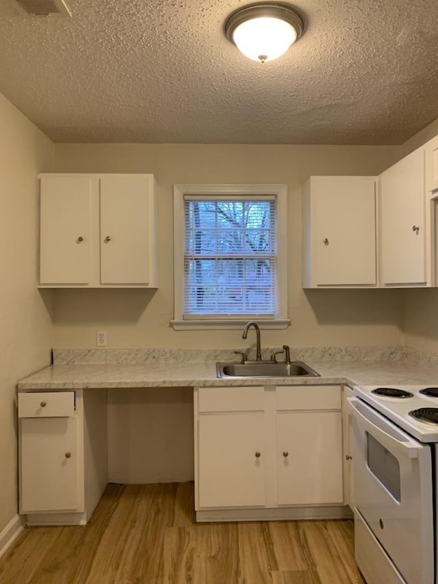 kitchen with sink, white cabinetry, a textured ceiling, electric stove, and light hardwood / wood-style floors