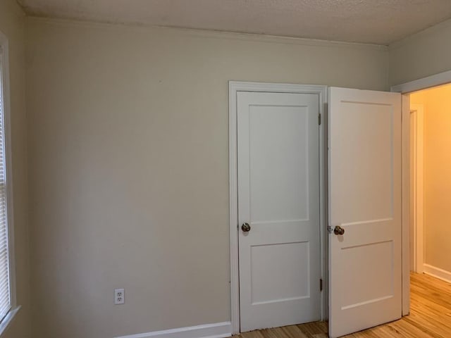 unfurnished bedroom featuring light hardwood / wood-style floors and a textured ceiling