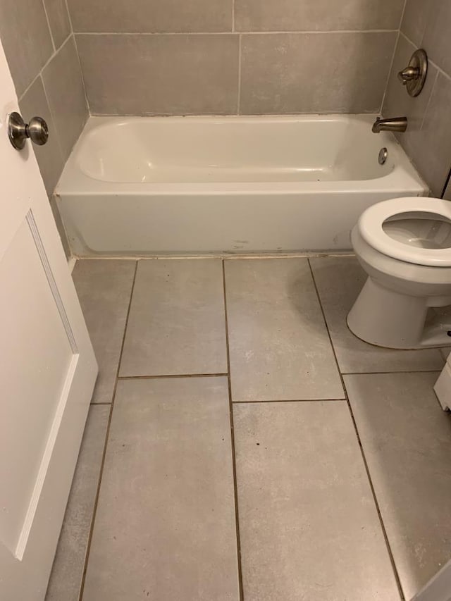 bathroom with toilet and tile patterned flooring