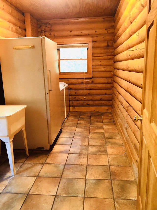 bathroom with rustic walls and wooden ceiling