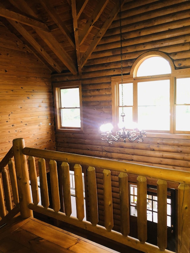 stairs featuring high vaulted ceiling, a notable chandelier, and log walls