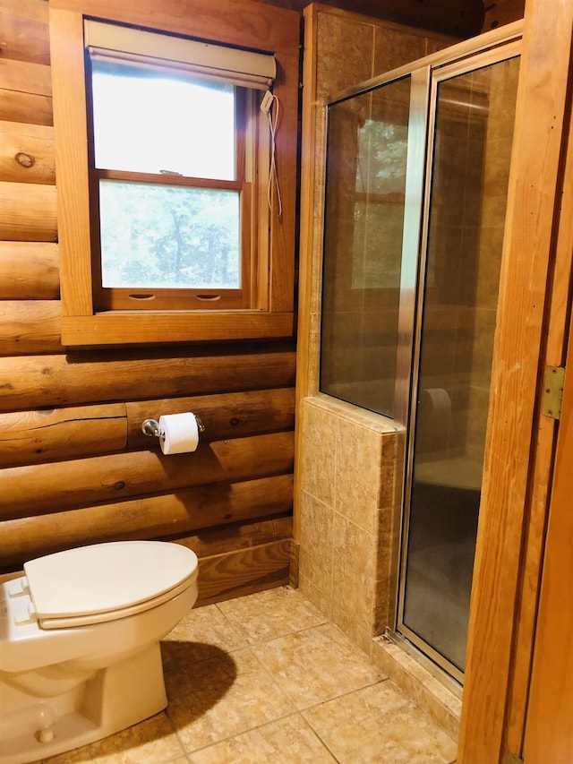 bathroom with a stall shower, log walls, toilet, and tile patterned floors